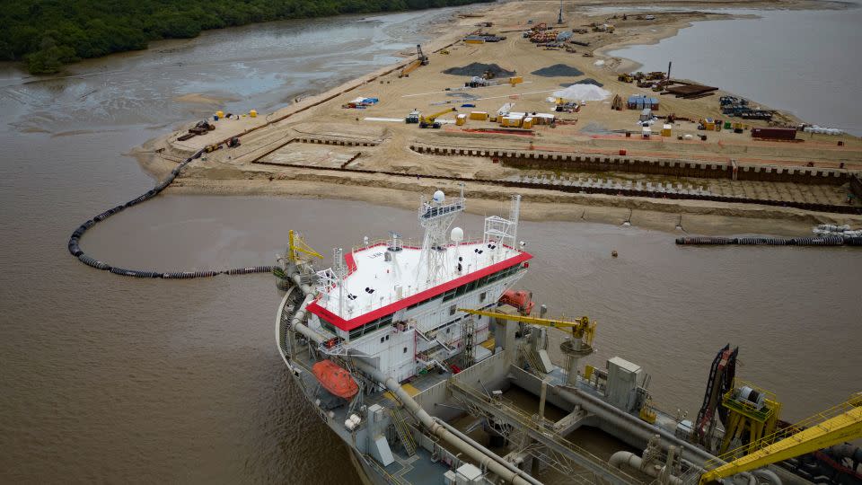 A ship creates an artificial island by extracting offshore sand to create a coastal port for offshore oil production at the mouth of the Demerara River in Georgetown, Guyana, on April 11, 2023. Guyana is on track to become the world’s highest per capita oil producer. - Matias Delacroix/AP