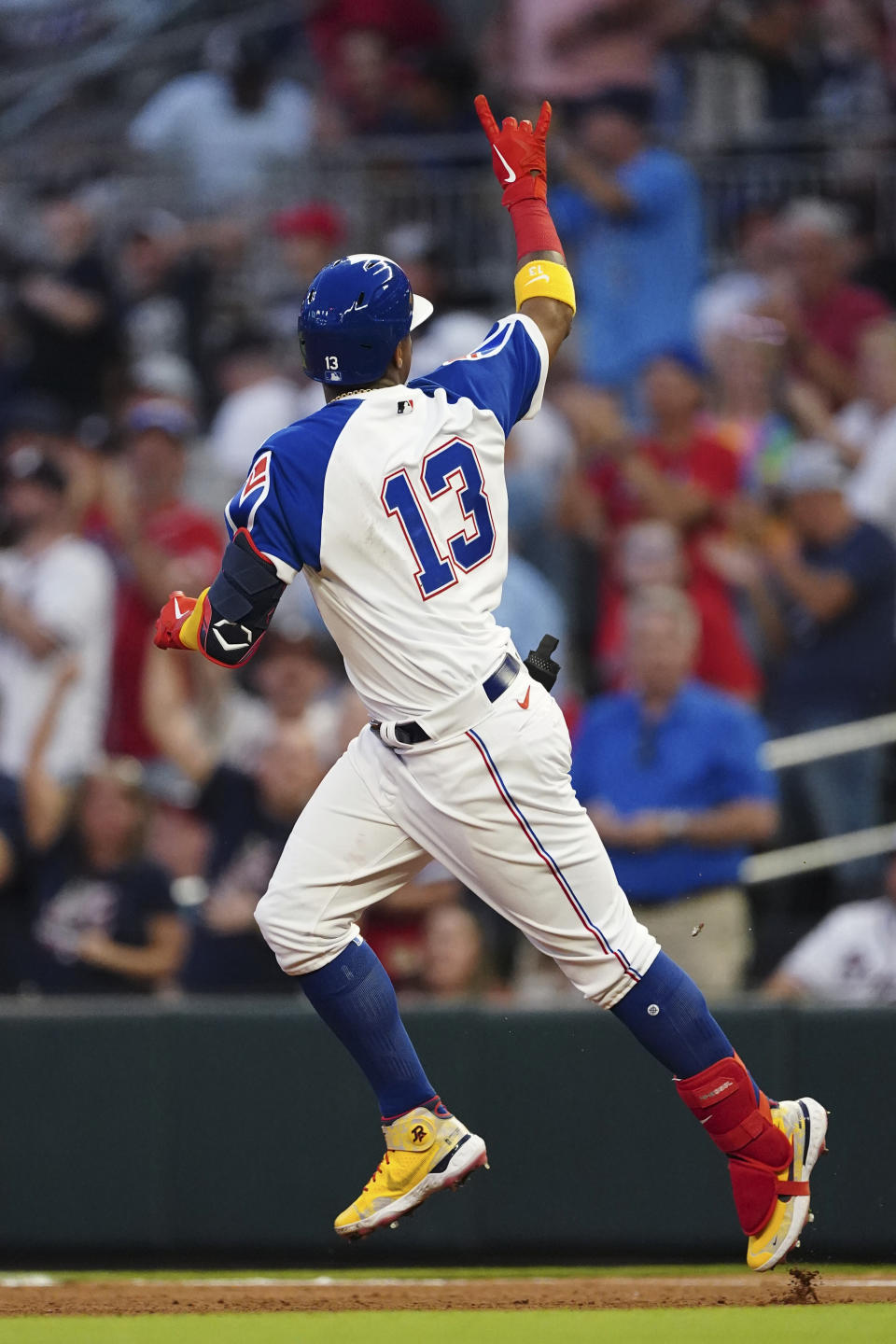 Atlanta Braves' Ronald Acuna Jr. gestures to the crowd as he runs the bases after hitting a home run during the fourth inning of the team's baseball game against the Milwaukee Brewers on Friday, May 6, 2022, in Atlanta. (AP Photo/John Bazemore)