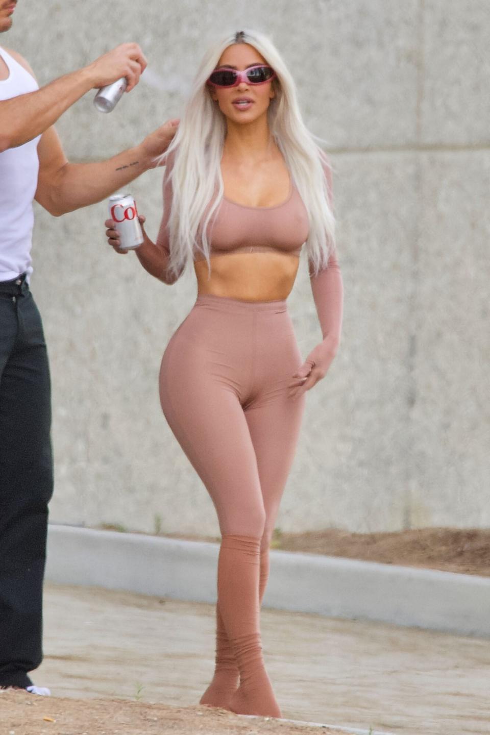 Mandatory Credit: Photo by D. Martinez/Shutterstock (12961216f) Kim Kardashian bares it all in sheer Skims outfit, posing for a photoshoot outside her office, Los Angeles, CA Kim Kardashian poses for photoshoot, holding a can of Coke outside her office, Los Angeles, CA - 27 May 2022