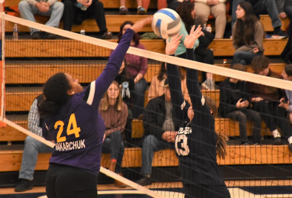 Morgan Russo tries to block a hit by Holland Patent Goden Knight Isabella Makarchuk (left) during the third game of Wednesday's match in Ilion.