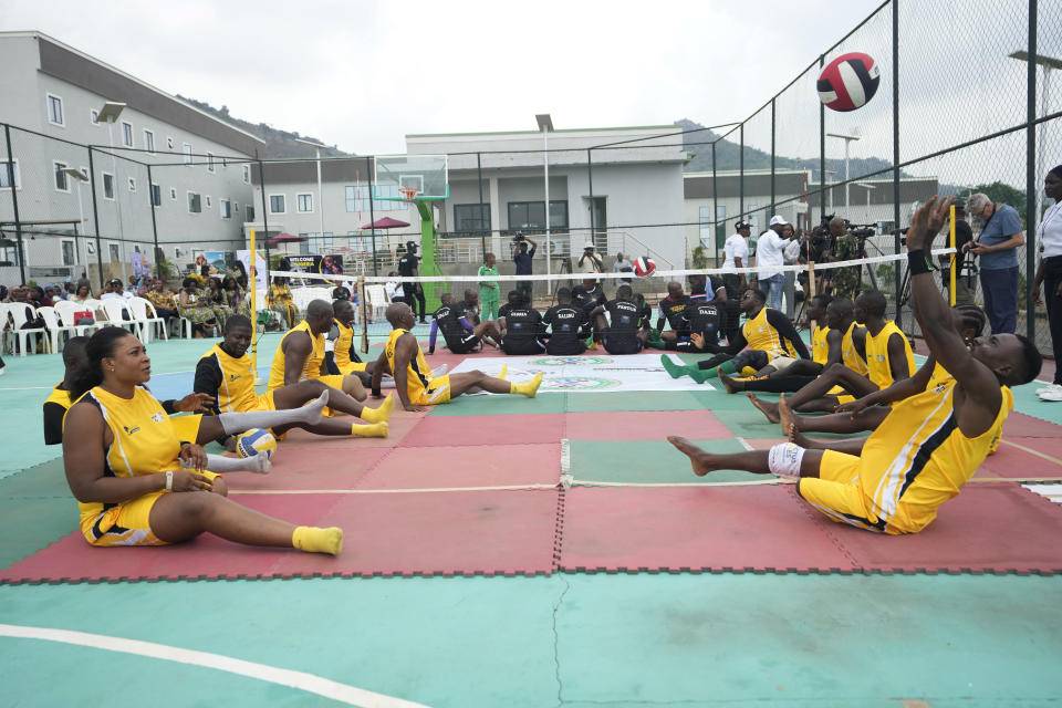 Peacemaker Azuegbulam, 27, Africa's first gold medalist at the Invictus Games, right, takes part in an exhibition sitting volleyball match in Abuja Nigeria, Saturday, May 11, 2024. He was among the soldiers deployed during Nigeria's grinding counter-offensive against Islamic extremists in the northeastern Borno state in 2020 when an anti-aircraft weapon was fired at them. By the time he regained consciousness, his life was no longer the same, starting with his left leg which was later amputated. (AP Photo/Sunday Alamba)