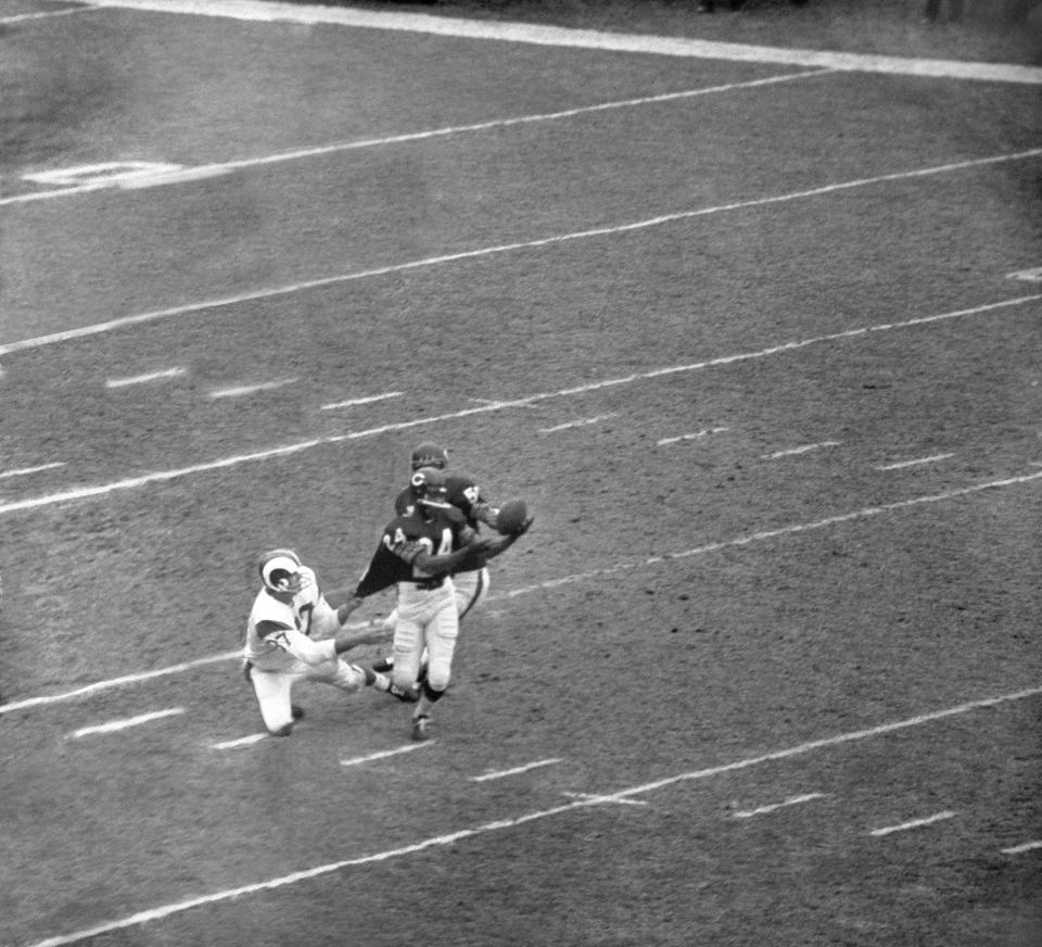 Roosevelt Taylor (24) of the Chicago Bears intercepts a pass intended for Billy Truax (87) of Los Angeles Rams, who has to settle for Taylors shirt tail in first period of game on Oct. 29, 1967, in Chicago. In the back is Doug Buffone (55) of Bears.