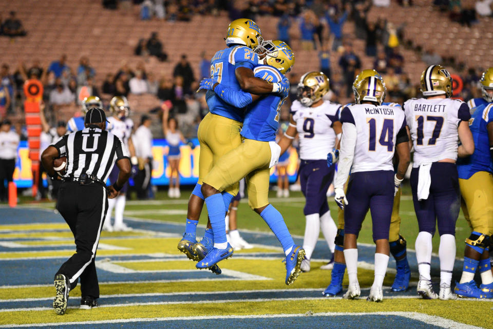 UCLA's Joshua Kelley (27) and Demetric Felton (10) hope to do more celebrating this week against USC. (Photo by Brian Rothmuller/Icon Sportswire via Getty Images)