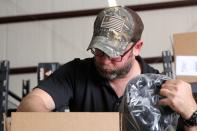 Mira Safety employee Clay, who declined to provide his last name, is seen packing orders to be shipped out from the company's warehouse in Austin