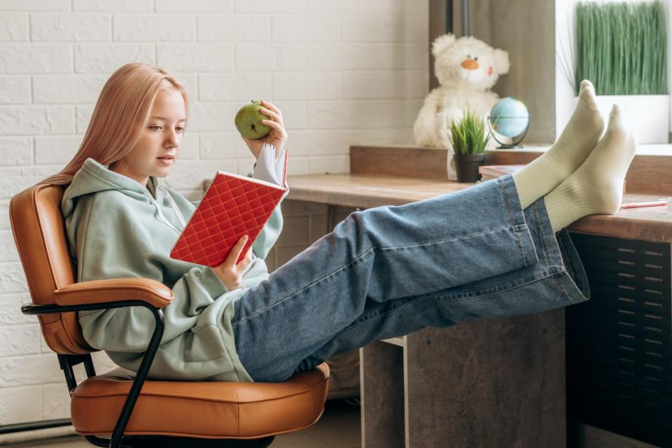 Along with your assignments, it’s good to read for at least 20 minutes a day. <a href="https://www.gettyimages.com/detail/photo/pretty-blonde-teenage-girl-in-home-clothes-reading-royalty-free-image/1333902073?phrase=teenage%2Bgirl%2Breading%2Ba%2Bbook%2Bin%2Broom%2Bat%2Bdesk" rel="nofollow noopener" target="_blank" data-ylk="slk:Tatiana Buzmakova/iStock via Getty Images Plus;elm:context_link;itc:0;sec:content-canvas" class="link ">Tatiana Buzmakova/iStock via Getty Images Plus</a>