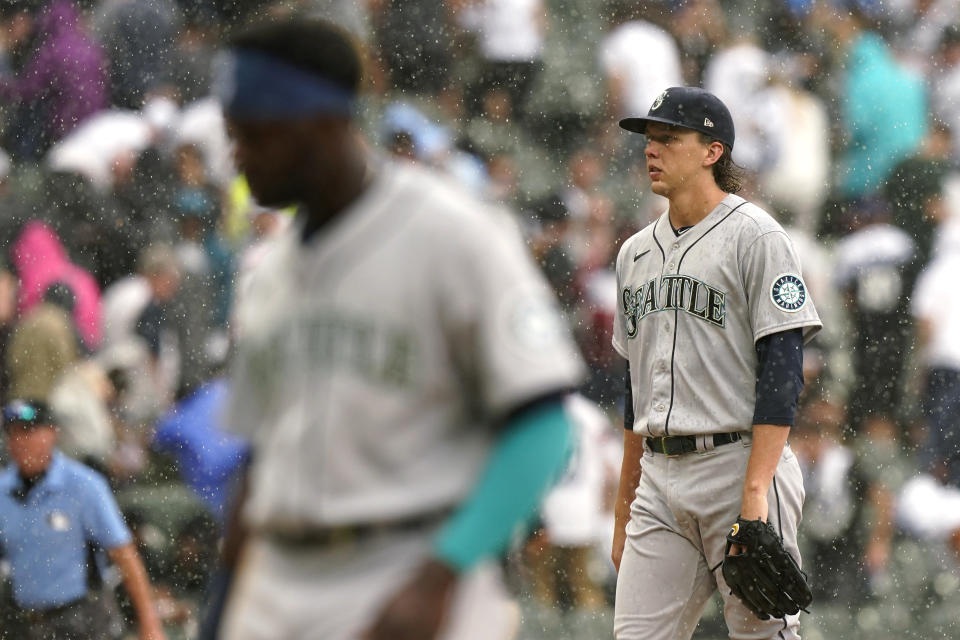 Seattle Mariners starting pitcher Logan Gilbert walks to the dugout during a rain delay in the third inning of a baseball game against the Chicago White Sox in Chicago, Saturday, June 26, 2021. (AP Photo/Nam Y. Huh)