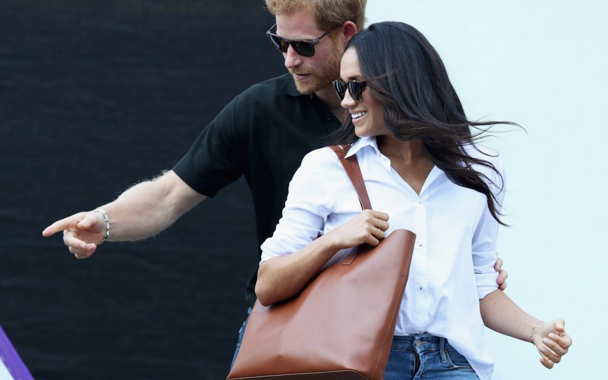 Meghan Markle with Prince Harry at the Invictus Games in 2017 - Getty Images