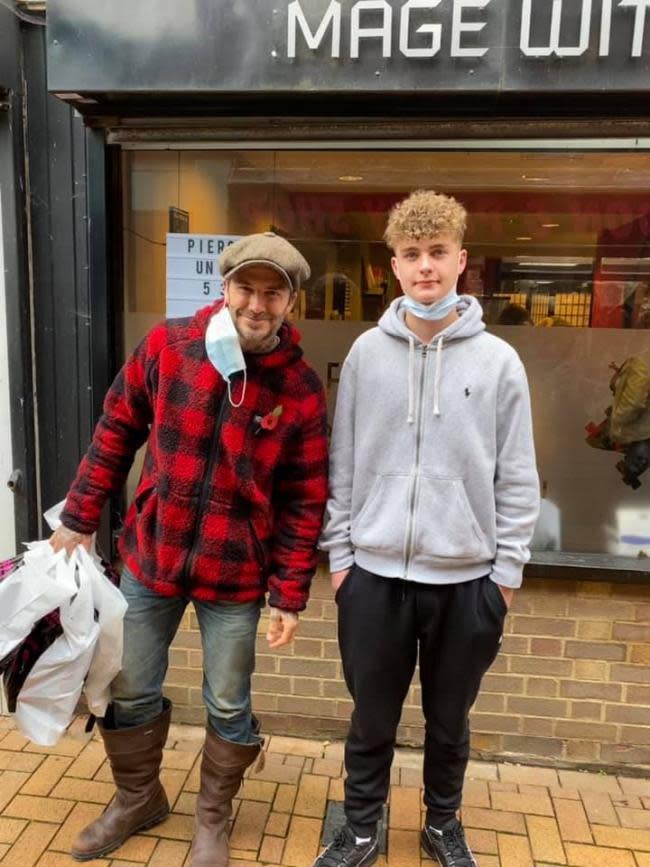 Oxford Mail: David Beckham with fan Addison Smiley outside Sweet Celebrations party shop in Banbury