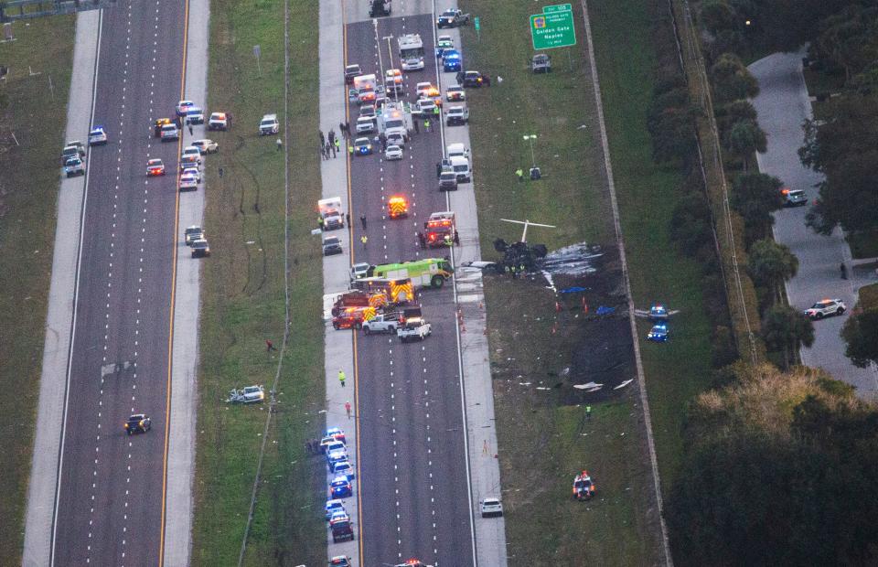 Emergency officials work the scene of plane crash on I-75 in Naples near exit 105 on Friday, Feb. 9, 2024. Two people were confirmed dead.