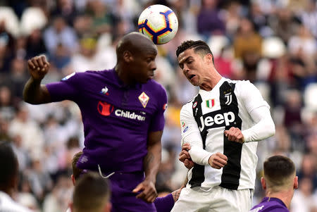 Soccer Football - Serie A - Juventus v Fiorentina - Allianz Stadium, Turin, Italy - April 20, 2019 Juventus' Cristiano Ronaldo in action with Fiorentina's Bryan Dabo REUTERS/Massimo Pinca