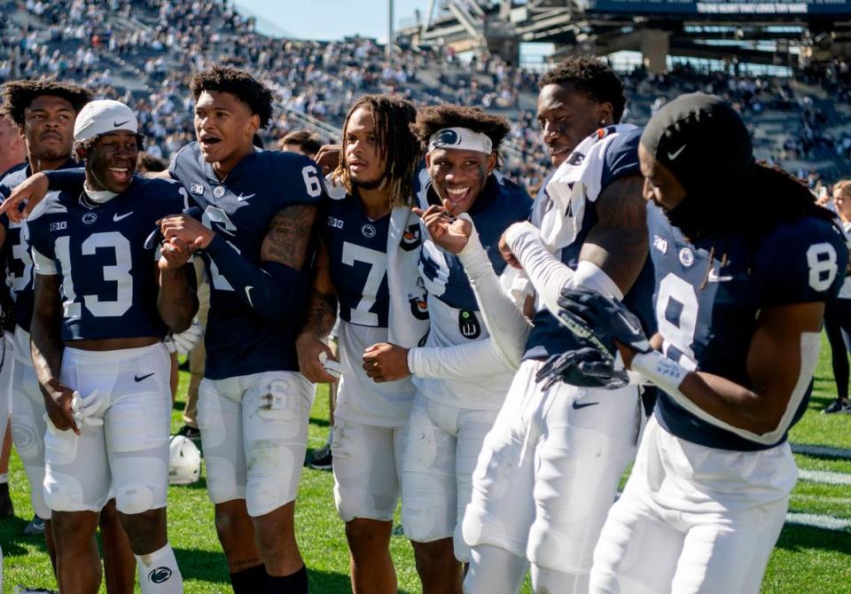 Penn State football players laugh together as they sing and dance to the Penn State alma mater after the win over Central Michigan on Saturday, Sept. 24, 2022.