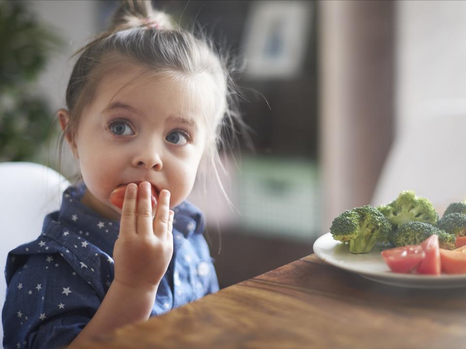 girl eating vegetables healthy