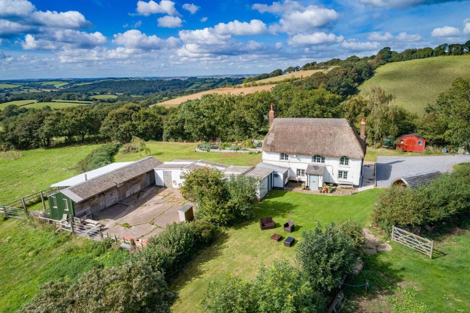 <p>How pretty is this charming Grade II listed cottage in Devon? With a traditional thatched roof, stunning wraparound countryside views and additional outbuildings, it really is a dream. Take a peek inside...</p><p><a href="https://www.onthemarket.com/details/8510590/" rel="nofollow noopener" target="_blank" data-ylk="slk:This property is on the market for £550,000 via Helmores at Onthemarket.com;elm:context_link;itc:0;sec:content-canvas" class="link ">This property is on the market for £550,000 via Helmores at Onthemarket.com</a>. </p>