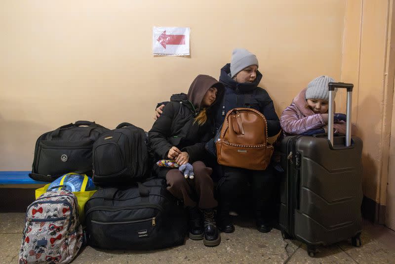 Lilya and her children Aryna and Katya, who fled their home in Novohrodivka after an increase in Russian missile strikes, wait for an evacuation train in Pokrovsk