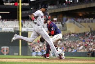 Cleveland Guardians' Oscar Gonzalez scores next to Minnesota Twins catcher Ryan Jeffers during the ninth inning of a baseball game Wednesday, June 22, 2022, in Minneapolis. (AP Photo/Andy Clayton-King)