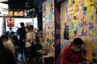 Customers sit inside a yellow restaurant called ''Mainichi'', during ''golden ween'' holiday by supporting local businesses with the pro-democracy views, in Hong Kong