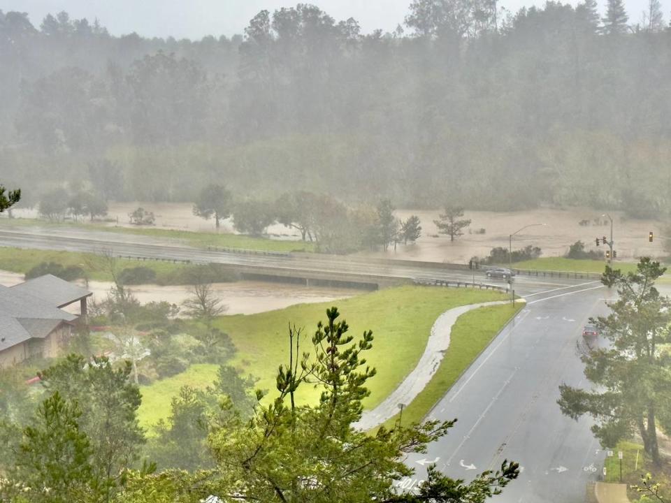 Waters rising near the intersection of Cambria Drive and Highway 1 over the Santa Rosa Creek in Cambria during a storm on March 10.
