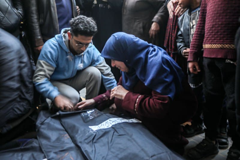 Relatives mourn as they receive the dead bodies of family members after an Israeli strike in Rafah in the southern Gaza Strip on Wednesday. Photo by Ismael Mohamad/UPI