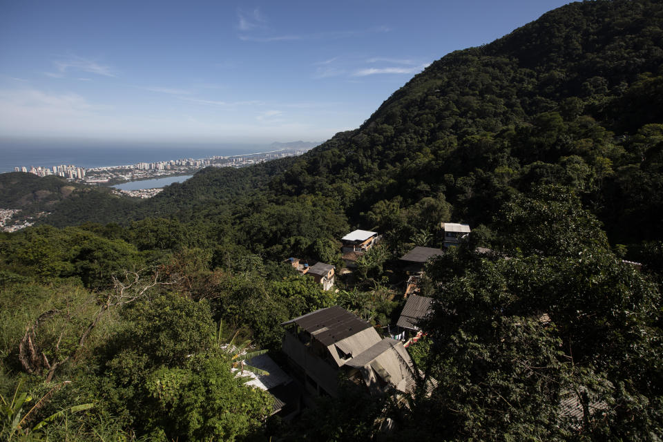 Houses in the Enchanted Valley sustainable community stand on the outskirts of Tijuca National Forest in Rio de Janeiro, Brazil, Monday, June 6, 2022. Electricity arrived in the late 20th century to the low-income Enchanted Valley community, but the utility never connected it to the city’s sewage network, so its residents set out to solve the problem on its own by building a biodigester and artificial wetland to process all sewage generated by all of its 40 families. (AP Photo/Bruna Prado)