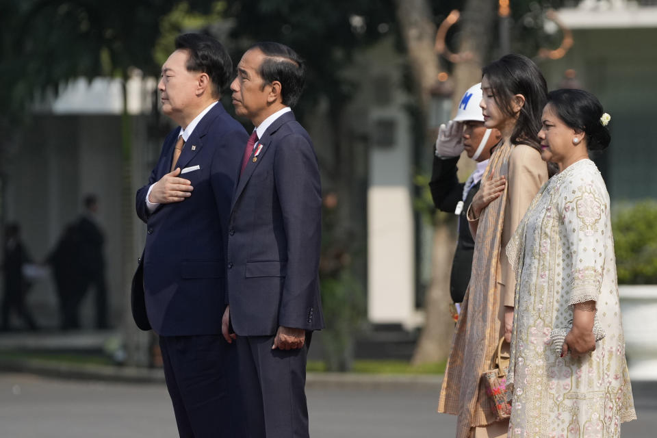 South Korean President Yoon Suk Yeol, left, and his wife Kim Keon Hee, second right, listen to the national anthems with Indonesian President Joko Widodo and his wife Iriana during the welcoming ceremony ahead of their meeting at Merdeka Palace in Jakarta, Indonesia, Friday, Sept. 8, 2023. (AP Photo/Achmad Ibrahim)