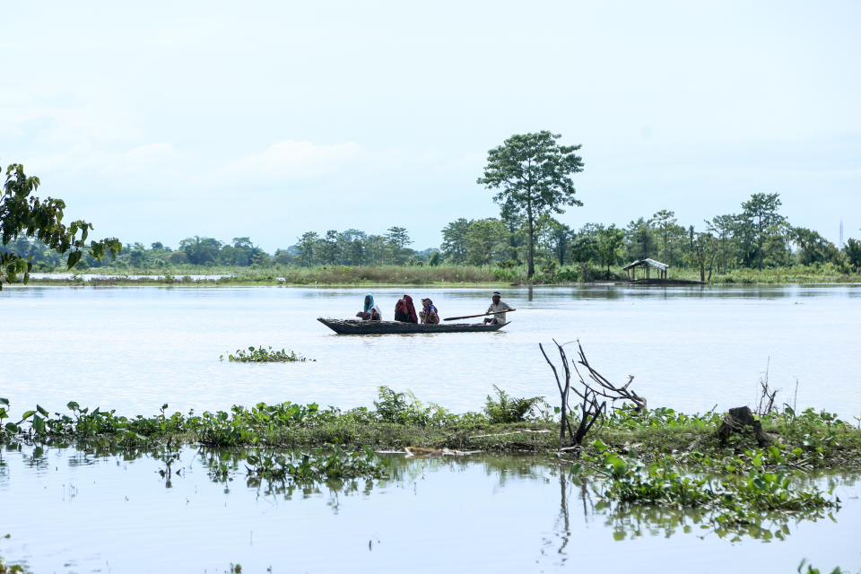 Villagers travel on a boat at the flood affected area of Laibil village in Sibsagar district of Assam, India, on July 22, 2020. (Photo by Dimpy Gogoi/NurPhoto via Getty Images)