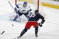 Tampa Bay Lightning's Andrei Vasilevskiy, top, of Russia, makes a save against Columbus Blue Jackets' Alexandre Texier, of France, during the second period of an NHL hockey game Saturday, Jan. 23, 2021, in Columbus, Ohio. (AP Photo/Jay LaPrete)