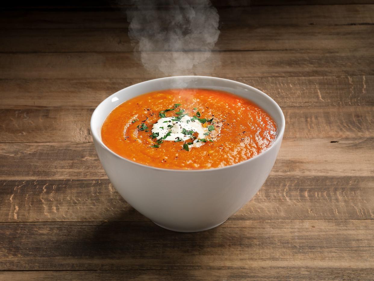 Tomato Soup with cheese and fresh mint leaves.