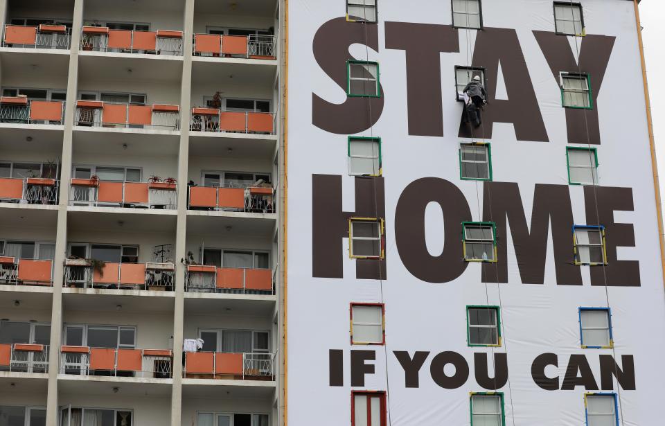 A billboard is installed on an apartment building in Cape Town, South Africa, on March 25, 2020.