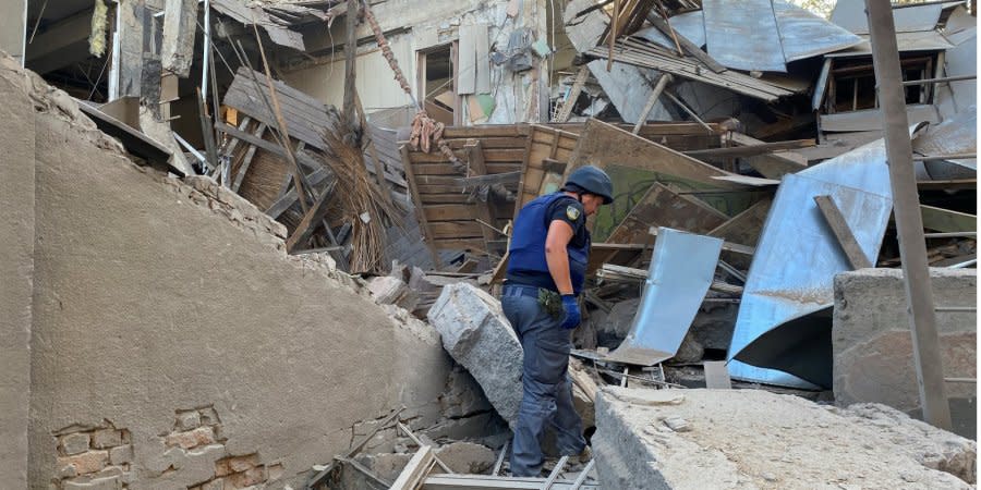 Rescuers inspect the rubble of a destroyed building in Kharkiv