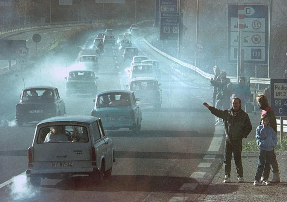 East German Trabant cars make their way past East Germans who have crossed the former border checkpoint Rudolphstein in Bavaria on motorway A9 after the opening of the East German border was announced in this Nov. 11, 1989. (Photo: Reuters)