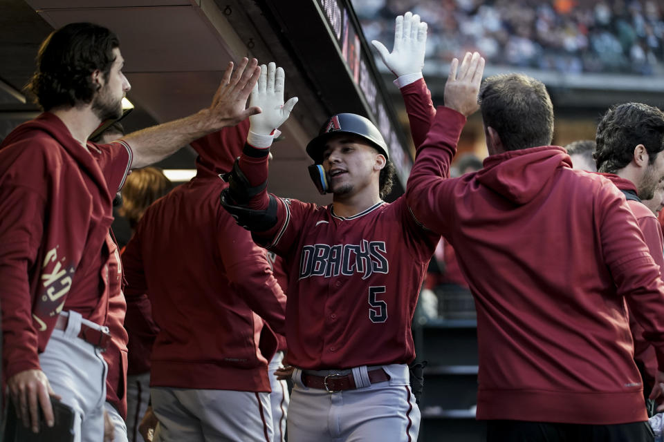 Arizona Diamondbacks' Alek Thomas (5) celebrates with teammates in the dugout after hitting a solo home run against the San Francisco Giants during the sixth inning of a baseball game Tuesday, Aug. 1, 2023, in San Francisco. (AP Photo/Godofredo A. Vásquez)