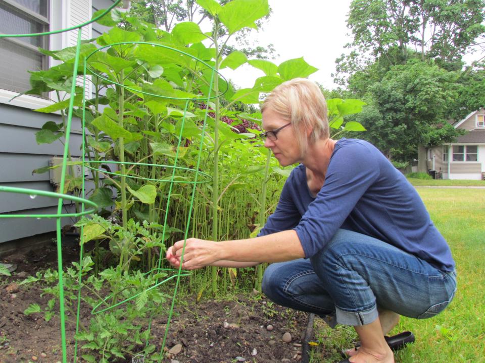 Jody Becker examines her vegetable garden on June 23, 2023.