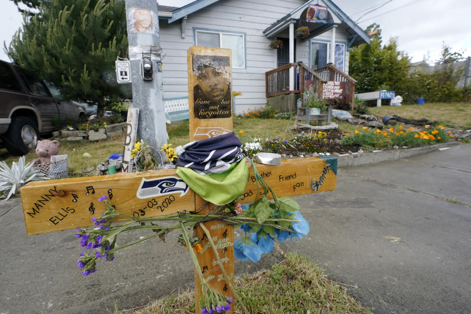 FILE - A sign that reads "Gone but not forgotten" is shown on a cross displayed May 27, 2021, at a memorial that has been established at the intersection in Tacoma, Wash., south of Seattle, where Manuel "Manny" Ellis died on March 3, 2020, after he was restrained by police officers. Opening statements are expected to begin as early as Tuesday, Oct. 3, 2023, in the trial of the three officers charged with Ellis' death. (AP Photo/Ted S. Warren, File)