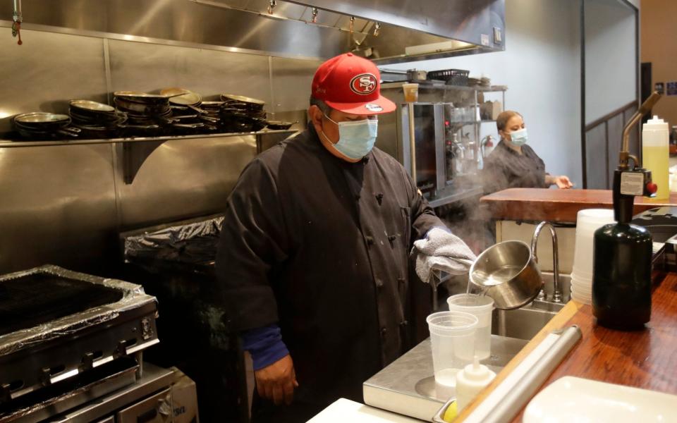 A chef in San Francisco. Restaurants have been forced to close again as cases soared - AP