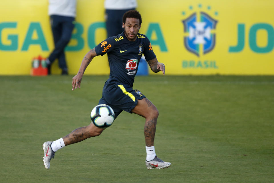 Brazil's soccer player Neymar runs for the ball during a practice session at the Granja Comary training center ahead of the Copa America tournament, in Teresopolis, Brazil, Tuesday, May 28, 2019. (AP Photo/Leo Correa)