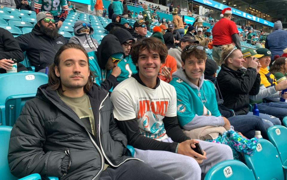Cristian Orth, center, is driving from Jupiter to Kansas City on Friday to attend Saturday's Dolphins at Chiefs playoff game.