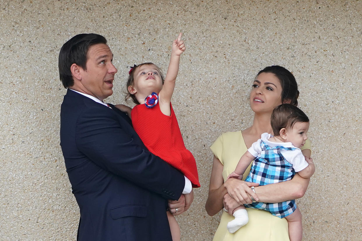 Ron DeSantis holds daughter Madison, and Casey DeSantis holds son Mason.