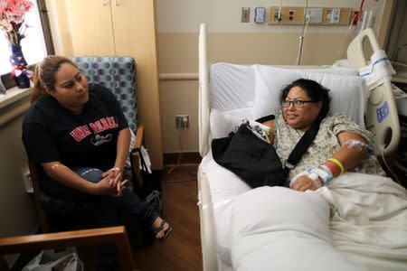 Paola Bautista, 39, from Fontana, California, (R) sits in her hospital bed next to her sister Daisy Bautista at Sunrise Hospital & Medical Center after being shot at the Route 91 music festival mass shooting next to the Mandalay Bay Resort and Casino in Las Vegas, Nevada, U.S. October 4, 2017. Picture taken October 4, 2017. REUTERS/Lucy Nicholson