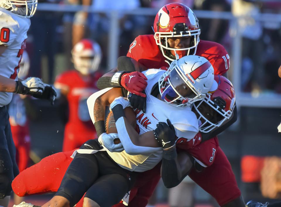 Dashawn Hopper (10) of Colerain is tackled by Breeon Ishmail (3) of Princeton during the Skyline Chili Crosstown Showdown at Pat Mancuso Field on Friday, Aug. 26