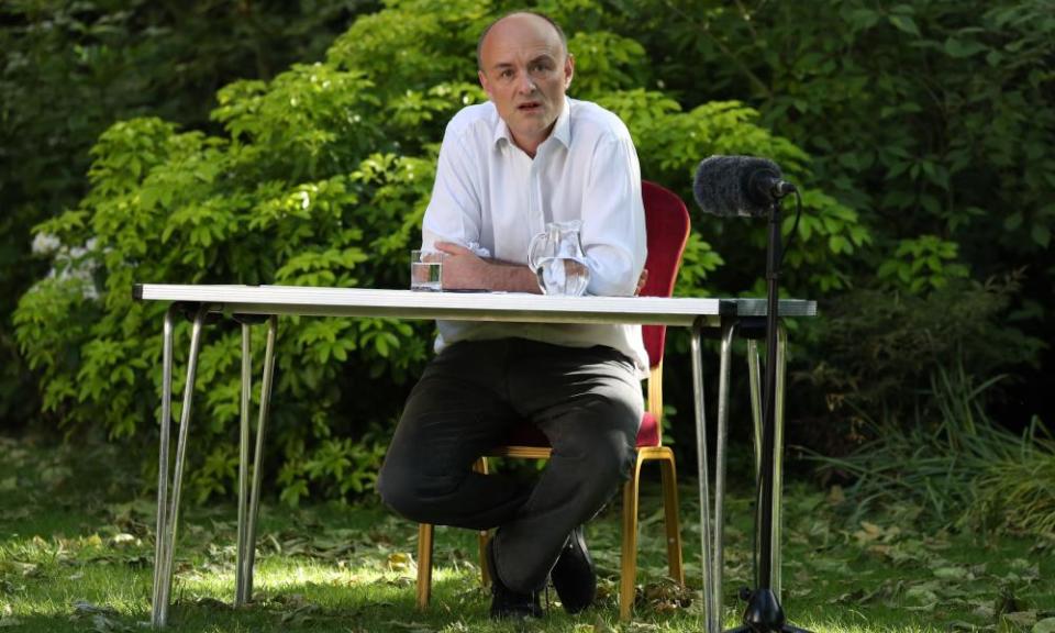 Dominic Cummings seated behind a table in the Rose Garden at 10 Downing Street