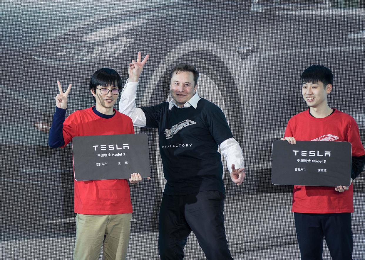 SHANGHAI, Jan. 7, 2020  -- Tesla CEO Elon Musk poses with Tesla China-made Model 3 vehicle owners during a ceremony in Shanghai, east China, Jan. 7, 2020.
  U.S. electric carmaker Tesla officially launched its China-made Model Y program in its Shanghai gigafactory Tuesday, one year after the company broke ground on its first overseas plant. The first batch of China-produced Model 3 sedans was also delivered to its non-employee customers at an opening ceremony for the program. (Photo by Ding Ting/Xinhua via Getty) (Xinhua/Ding Ting via Getty Images)