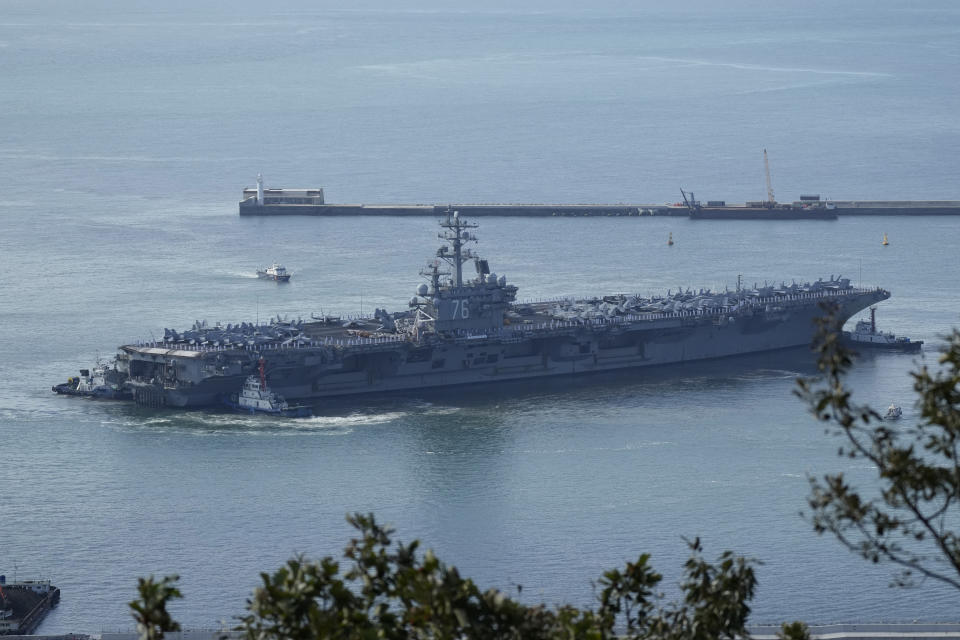 U.S. aircraft carrier USS Ronald Reagan is escorted into port in Busan, South Korea, Friday, Sept. 23, 2022. The USS Ronald Reagan arrived to participate in upcoming joint military drills with South Korea in the East Sea – the first time since 2017. (AP Photo/Lee Jin-man)