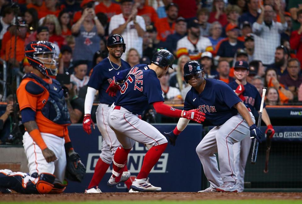 Red Sox center fielder Kike' Hernandez celebrates with third baseman Rafael Devers after hitting a solo home run.