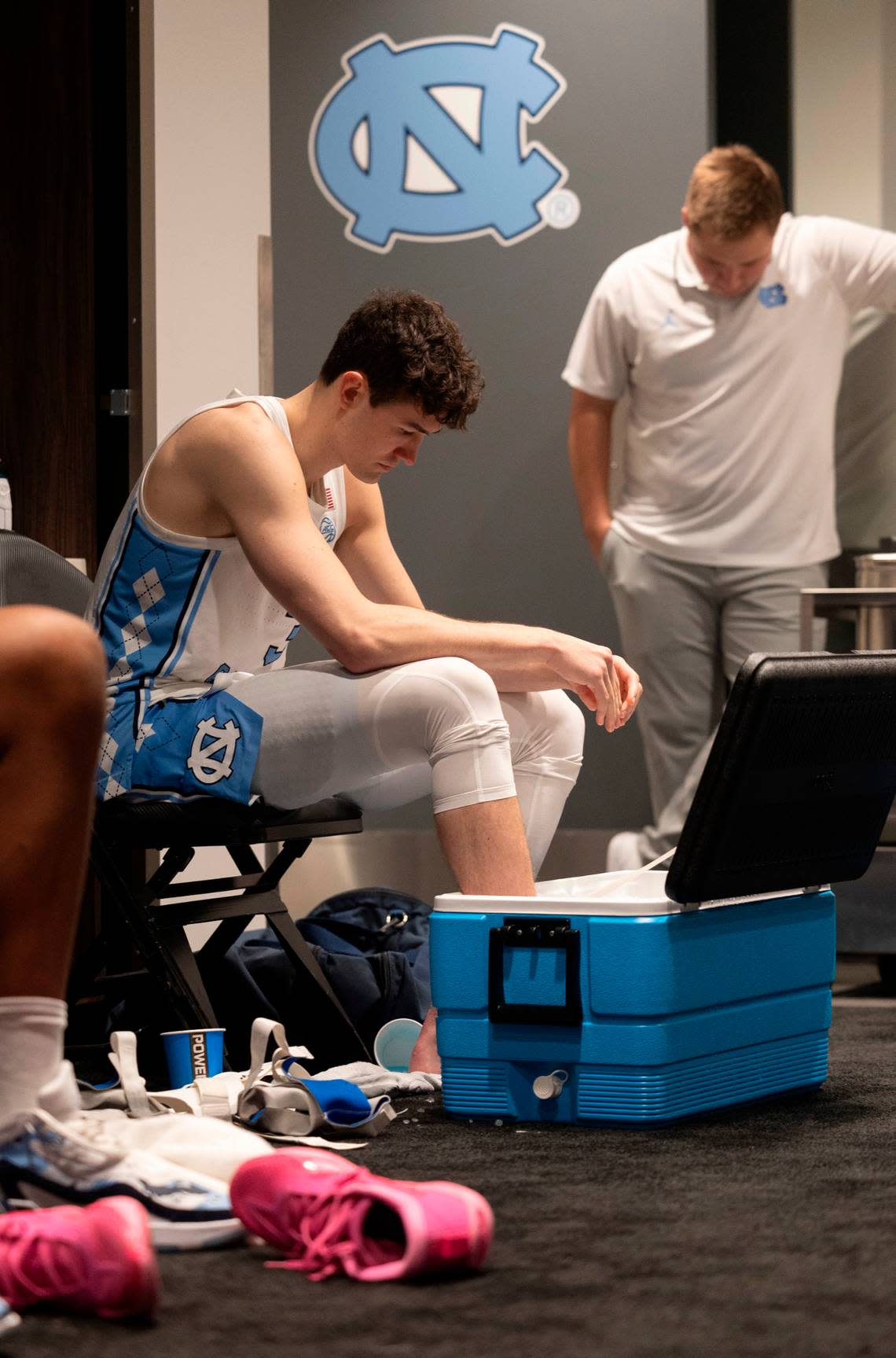 North Carolina’s Cormac Ryan (3) soaks his feet in a cooler inside the Tar Heels’ locker room following their 89-87 loss to Alabama in the West Regional on Thursday, March 28, 2024 at Crypto.com Arena in Los Angeles, CA.