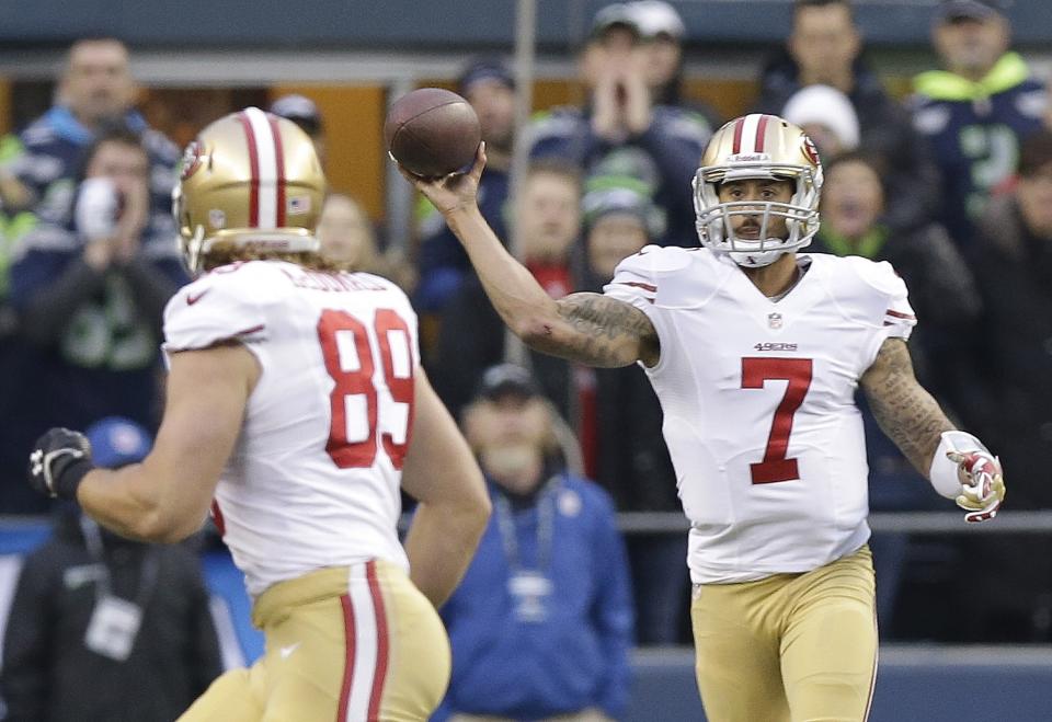 San Francisco 49ers' Colin Kaepernick throws to Vance McDonald during the first half of the NFL football NFC Championship game against the Seattle Seahawks Sunday, Jan. 19, 2014, in Seattle. (AP Photo/Elaine Thompson)