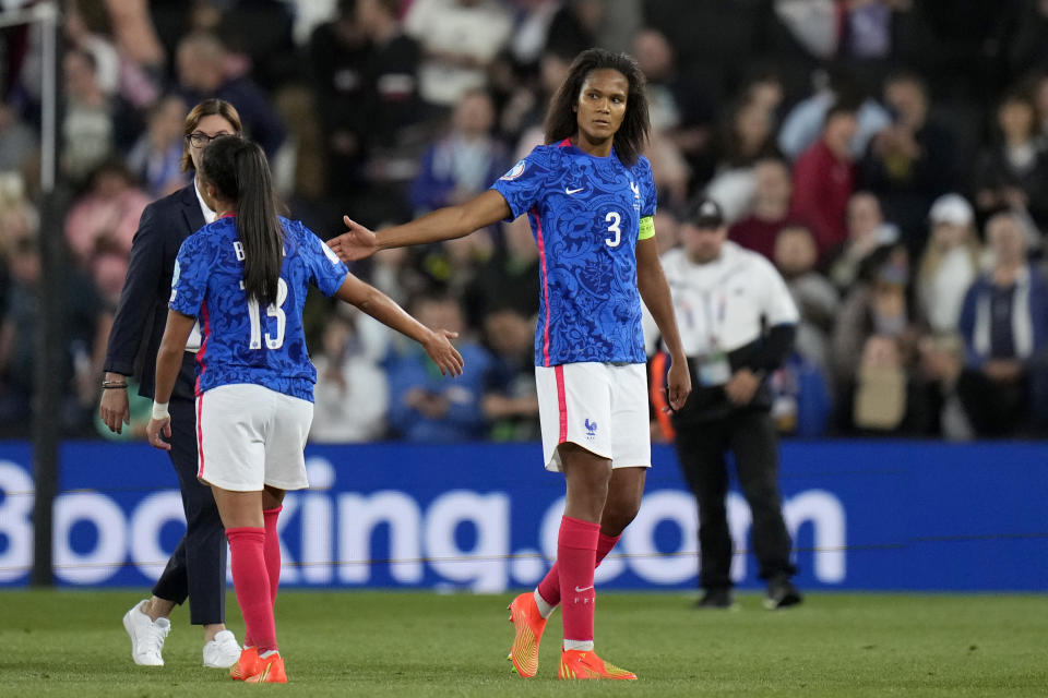 FILE - France's team captain Wendie Renard, right, touches hands with Selma Bacha at the end of the Women Euro 2022 semifinal soccer match between Germany and France at Stadium MK in Milton Keynes, England, Wednesday, July 27, 2022. Germany won 2-1 to advance to the final of the tournament. (AP Photo/Alessandra Tarantino, File)