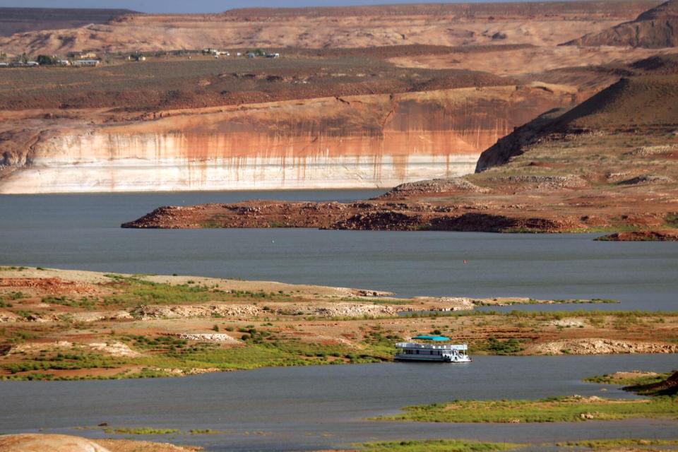 Houseboats float in a reservoir.