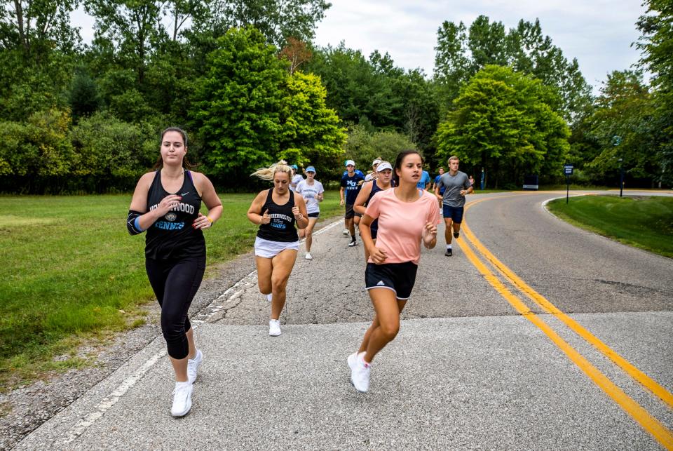 Iryna Trystan, 21, a Ukraine student from Northwood University, jogs with her teammates before the start of the first tennis practice of the season for Trystan in Midland on Thursday, Aug. 25, 2022. 
