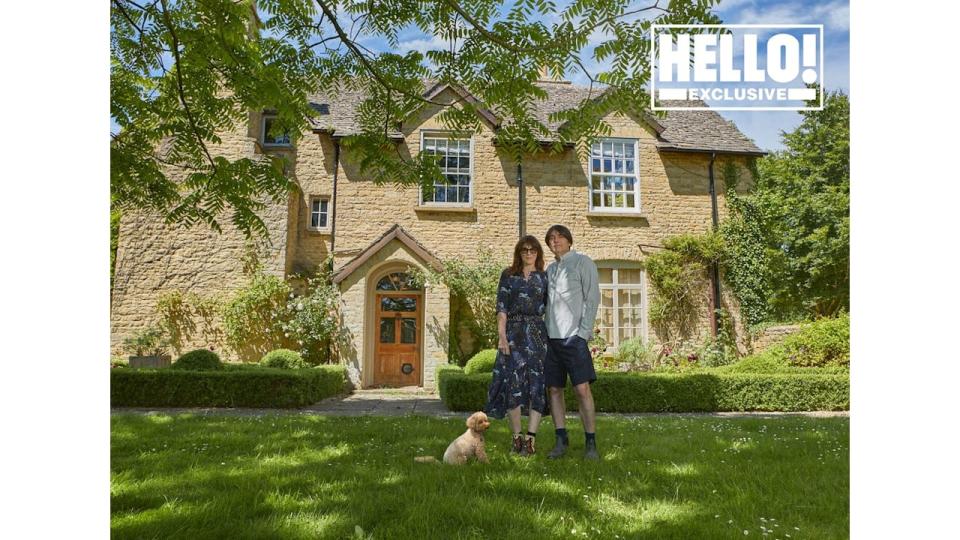 Blur star Alex James with wife Claire and pet dog posing outside farmhouse in Kingham, Oxfordshire 