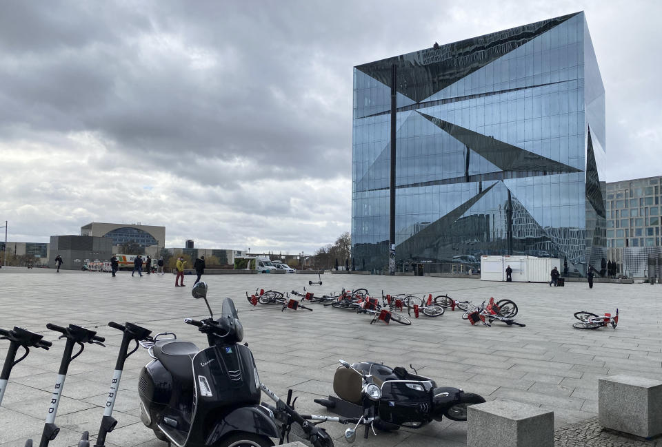 Bikes and a scooter lay on the ground during a storm in front of an office building near the central railway station in Berlin, Germany, Thursday, Feb. 17, 2022. Meteorologists warned Thursday that northern Europe could be battered by a series of storms over the coming days after strong winds swept across Germany, Denmark, Poland and the Czech Republic overnight, toppling trees and causing widespread delays to rail and air traffic. (AP Photo/Karl Ritter)